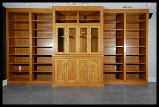 16ft Red Oak entertainment center; Mission style glass and solid doors, with floor-to-ceiling open bookcase bays.