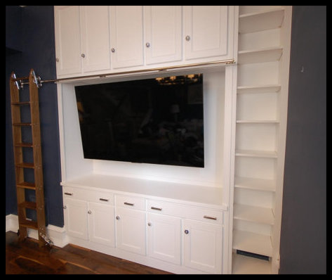 White Mission style entertainment center with widescreen TV, side bookcase, and stowed rolling library ladder; solid wood.