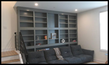 Premier example of a custom floor-to-ceiling wall-to-wall Maple library featuring light gray finish and architectural moldings.